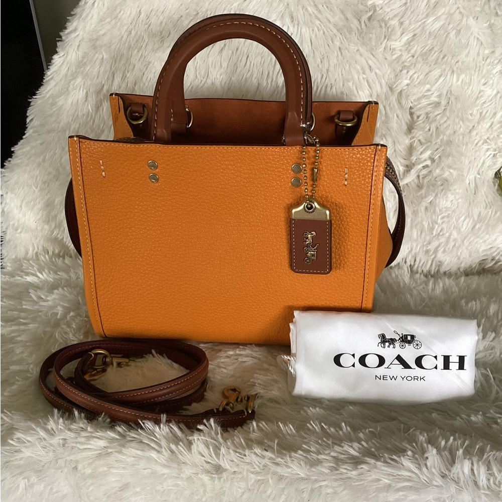 Coach Rogue 25" in Orange papaya color.